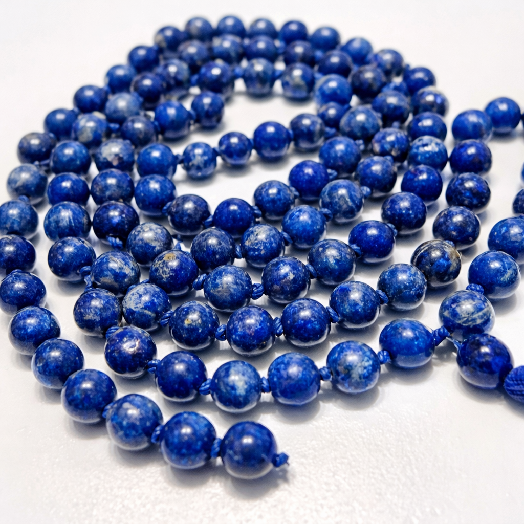 Long string of blue beads on a white background